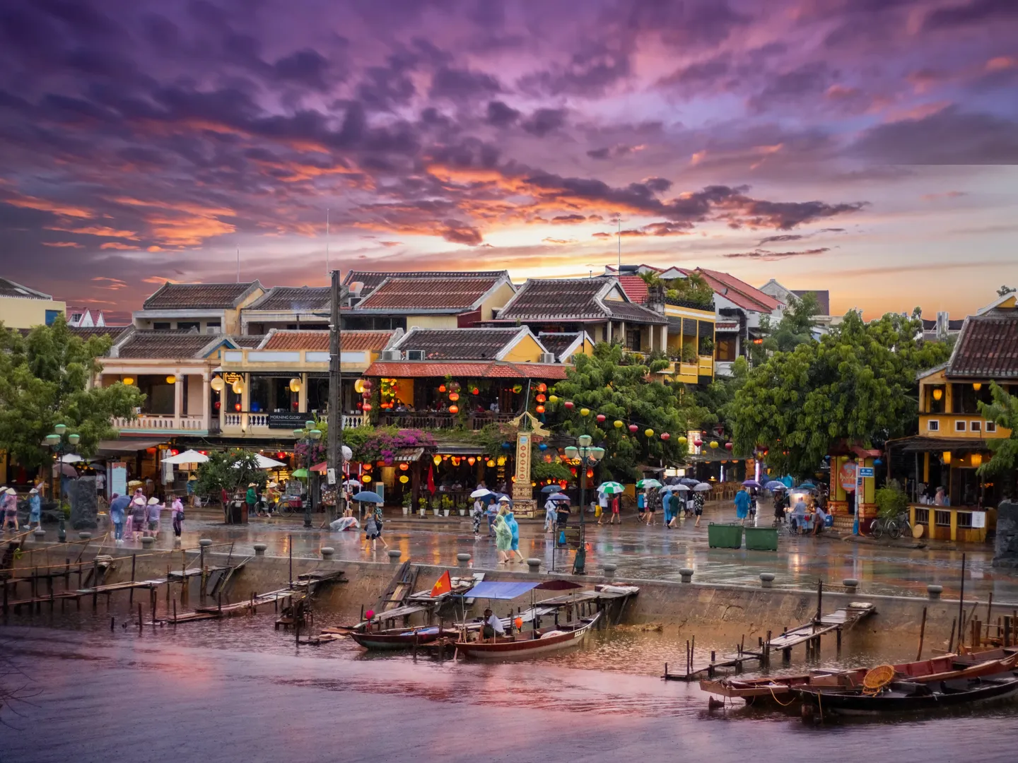  Aerial shot of Hoi An Old Town Harbour with traditional Vietnamese fishing and cruise boats at sunset in Hoi An, a popular holiday destination in Vietnam 