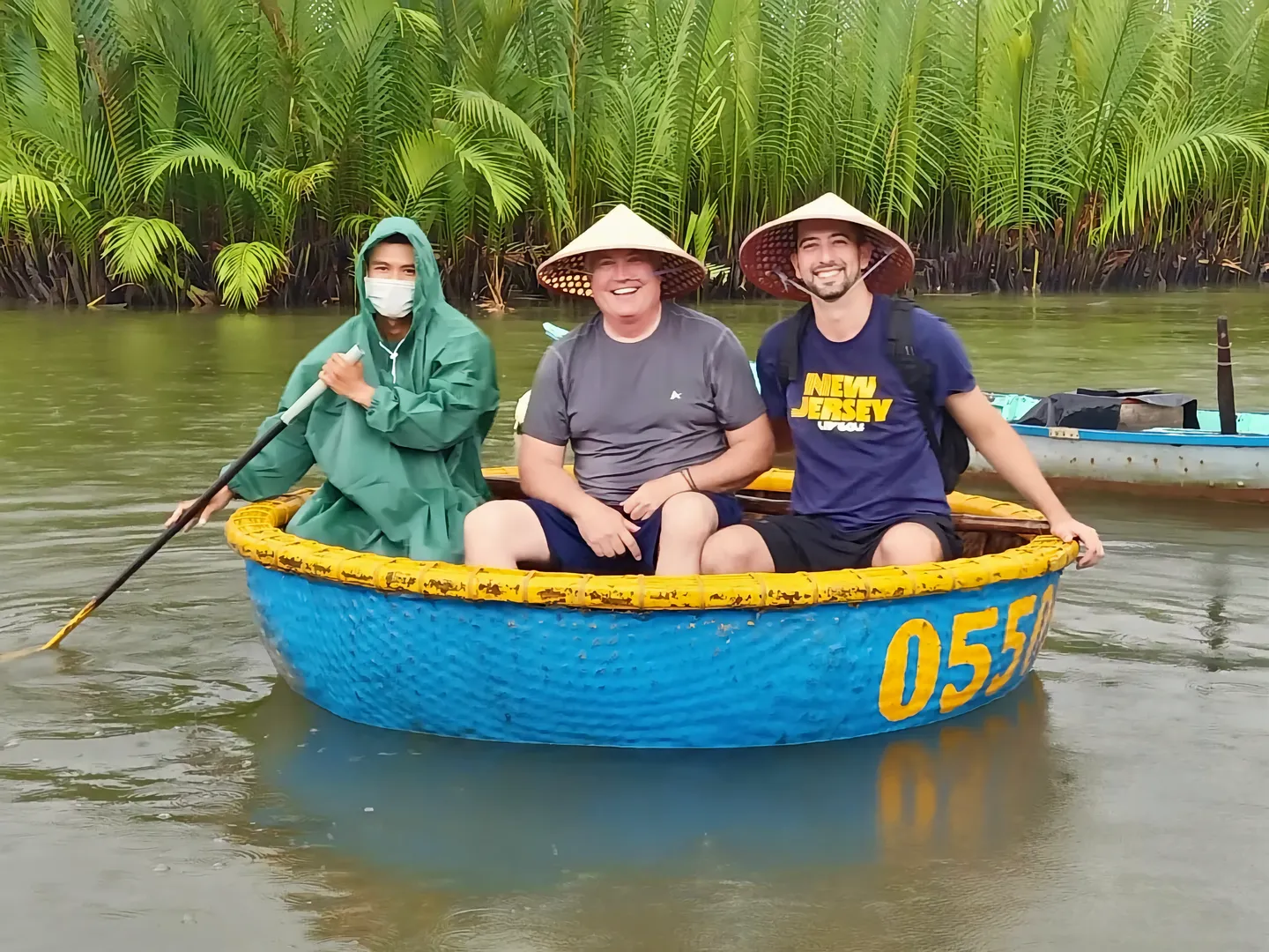  Tourists in Vietnamese basket boat posing for a camera in Hoi An, a popular holiday destination in Vietnam 