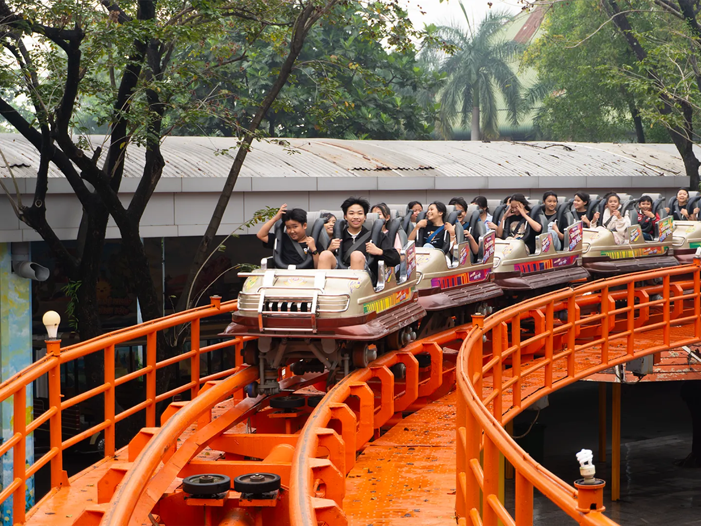  Visitors on a ride in Suoi Tien theme park located in Ho Chi Minh City, a popular holiday destination in Vietnam 