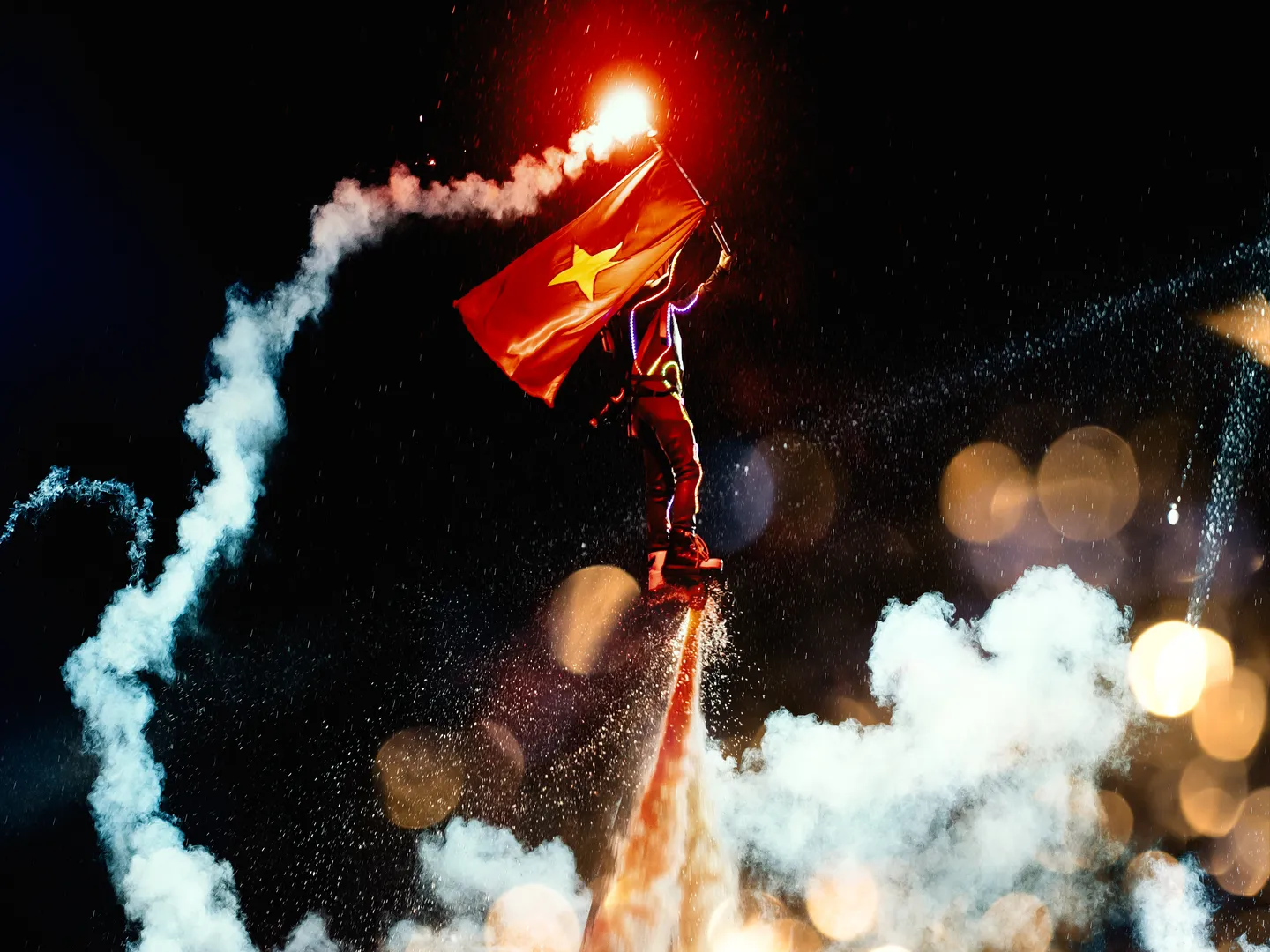  A jet-stream propelled rider following a jet-ski waving a national Vietnam flag during a National Day celebration in Suoi Tien theme park located in Ho Chi Minh City, a popular holiday destination in Vietnam 