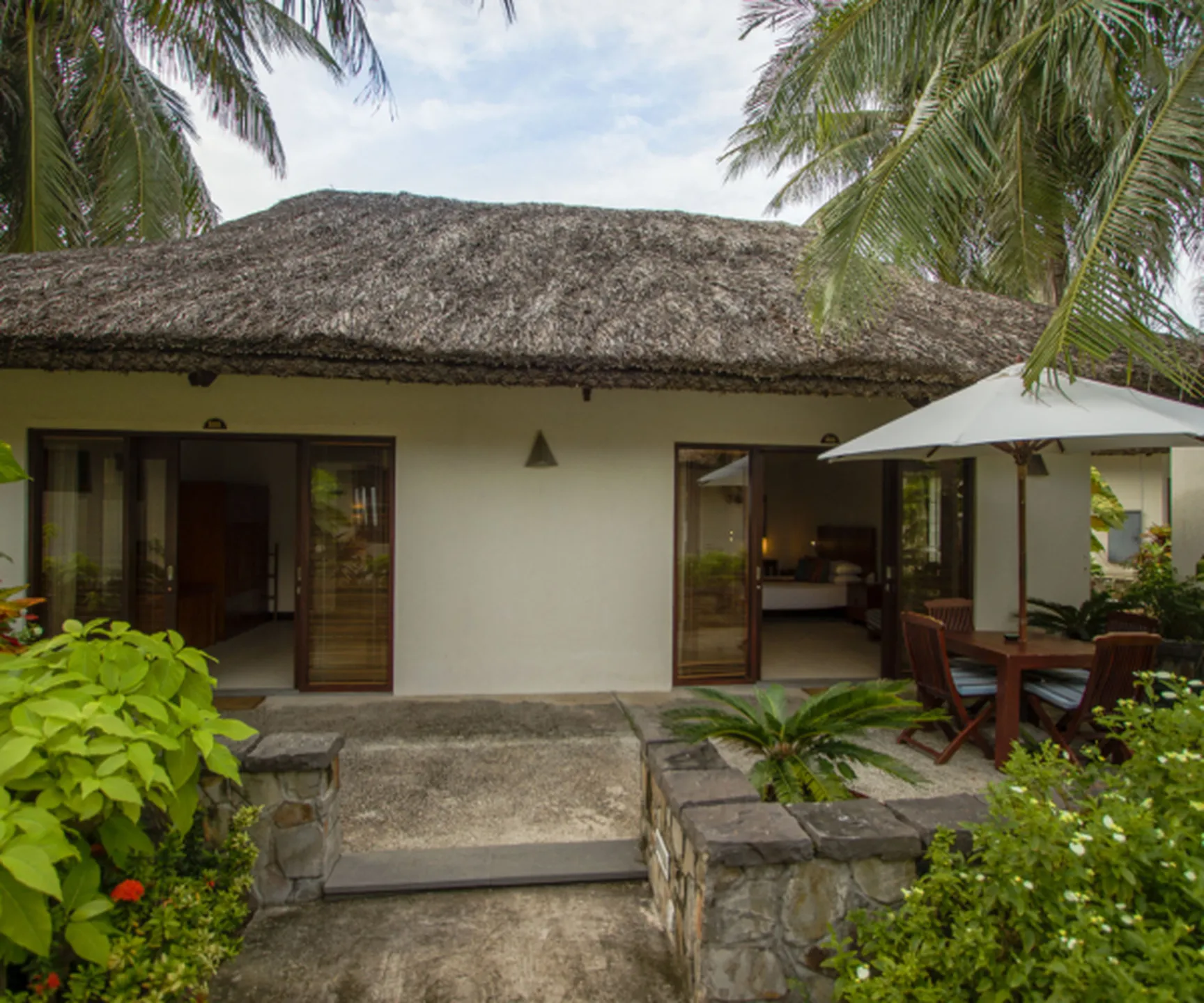 garden view family bungalow with terrace and tropical garden at Blue Ocean Resort Mui Ne Vietnam