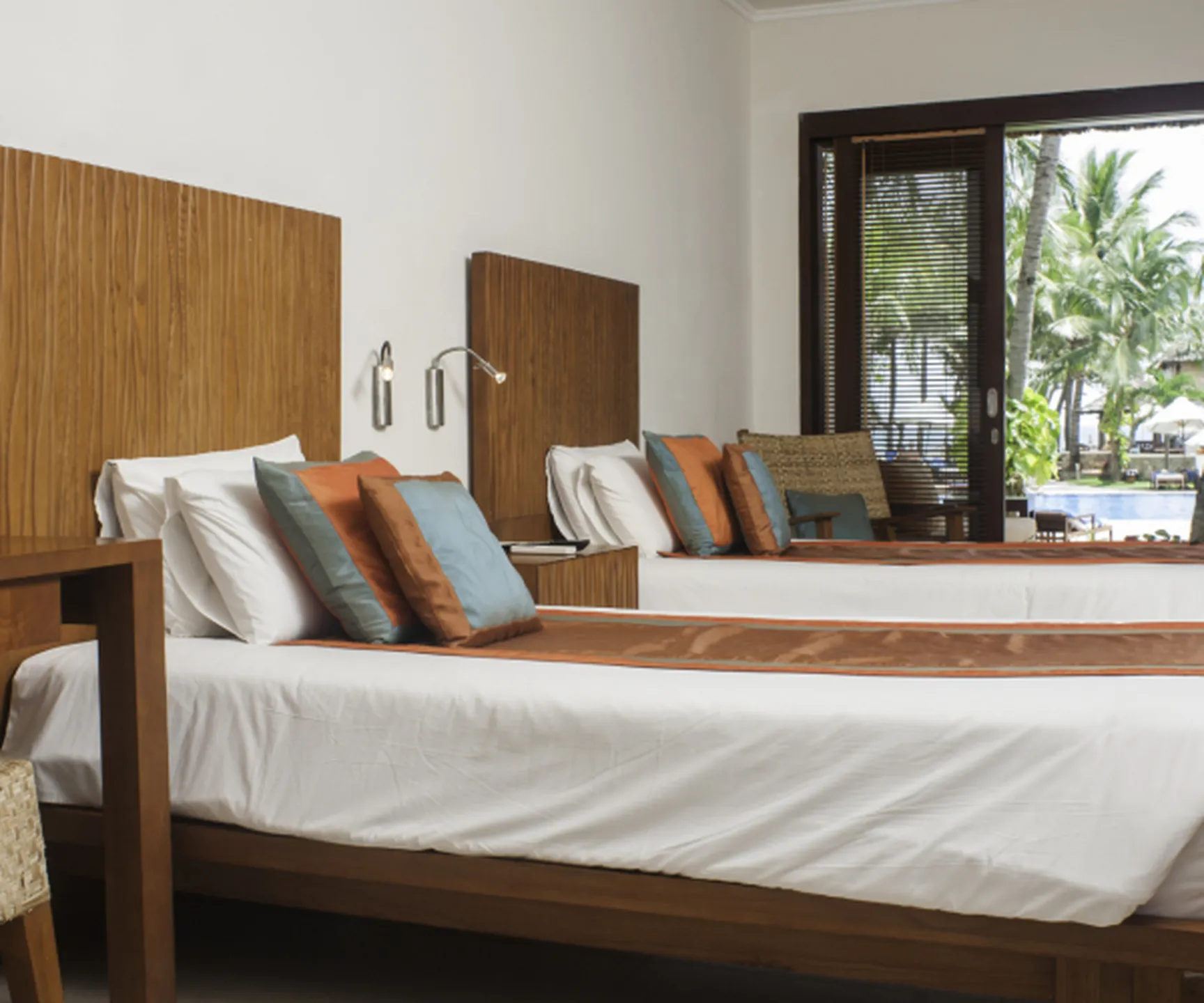  twin beds in pool view bungalow Blue Ocean Resort Mui Ne Vietnam with modern wooden interior 