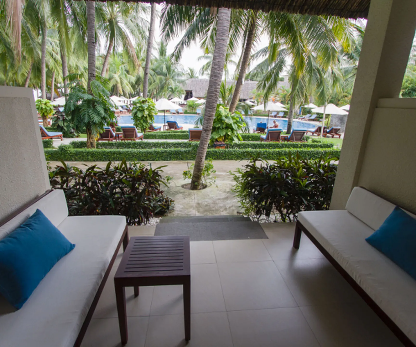  private terrace seating overlooking swimming pool at Blue Ocean Resort Mui Ne pool view bungalow 