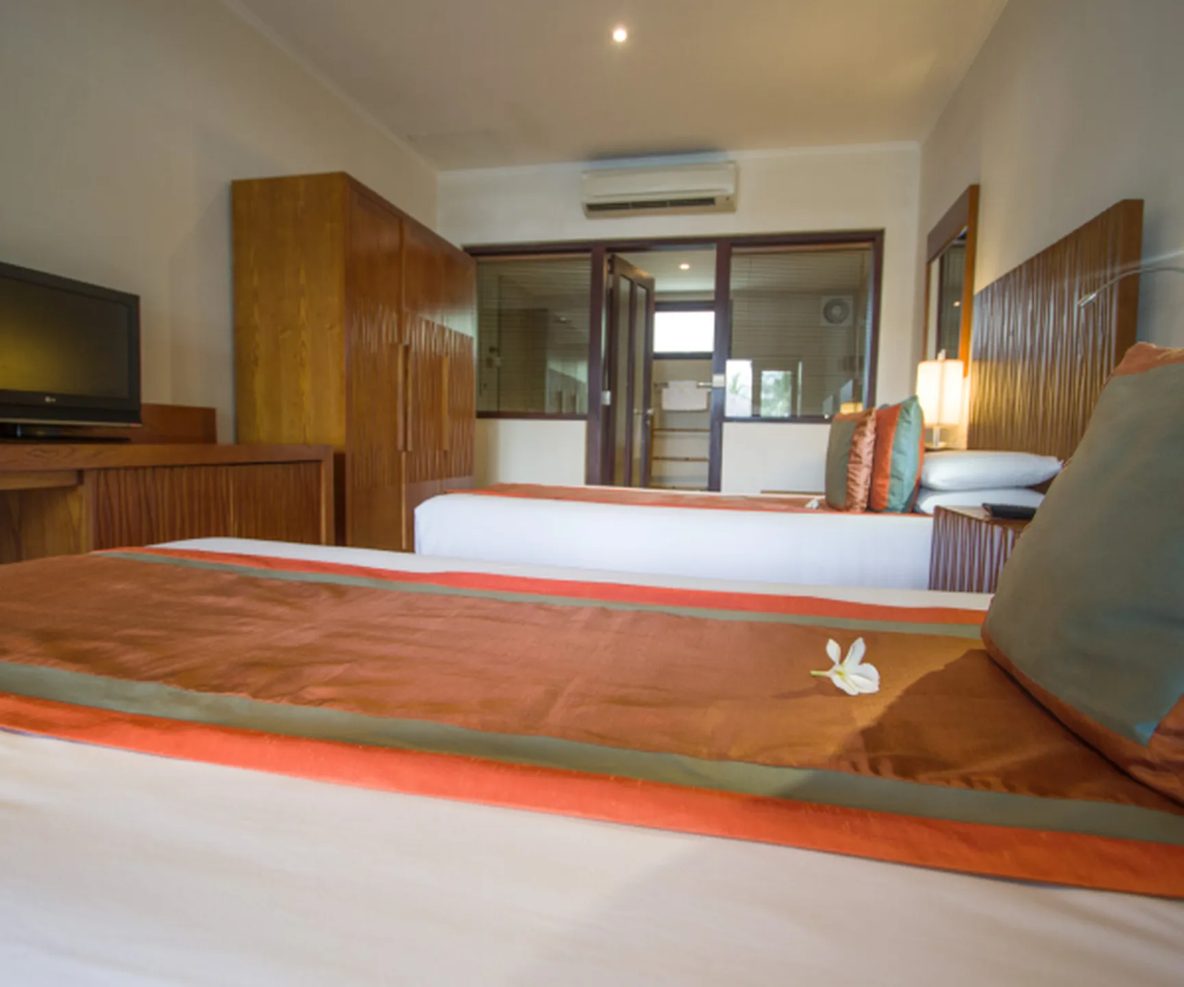  spacious interior with beds wardrobe and air conditioning in pool view bungalow Mui Ne Vietnam 