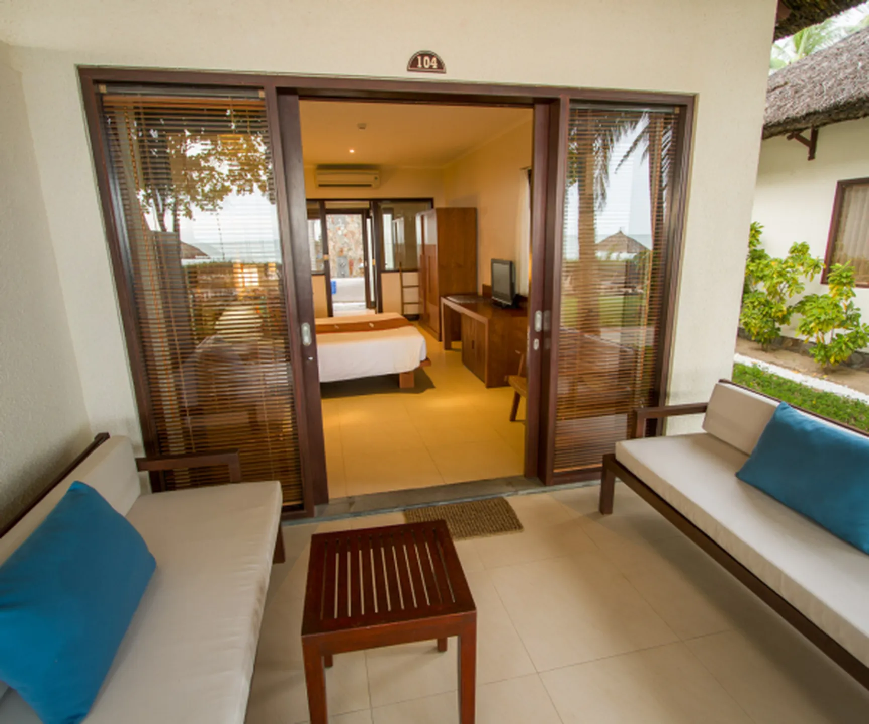  private patio seating area at sea view bungalow Blue Ocean Resort Mui Ne with garden surroundings 