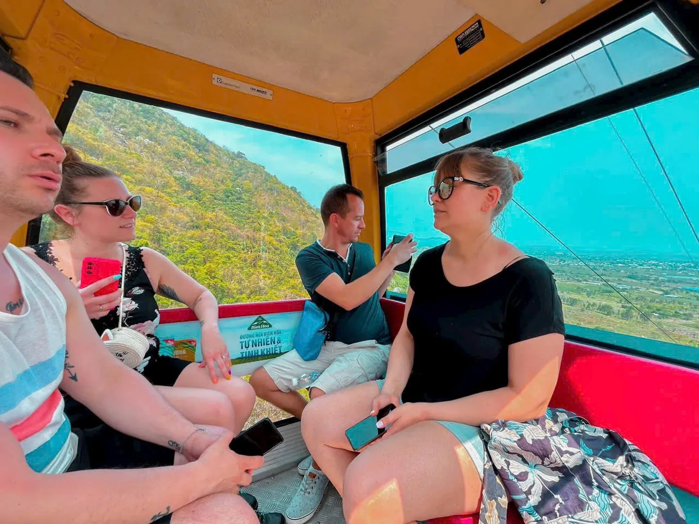  Visitors travel by cable car through the mountain landscape as part of the Ta Kou Mountain sightseeing experience 